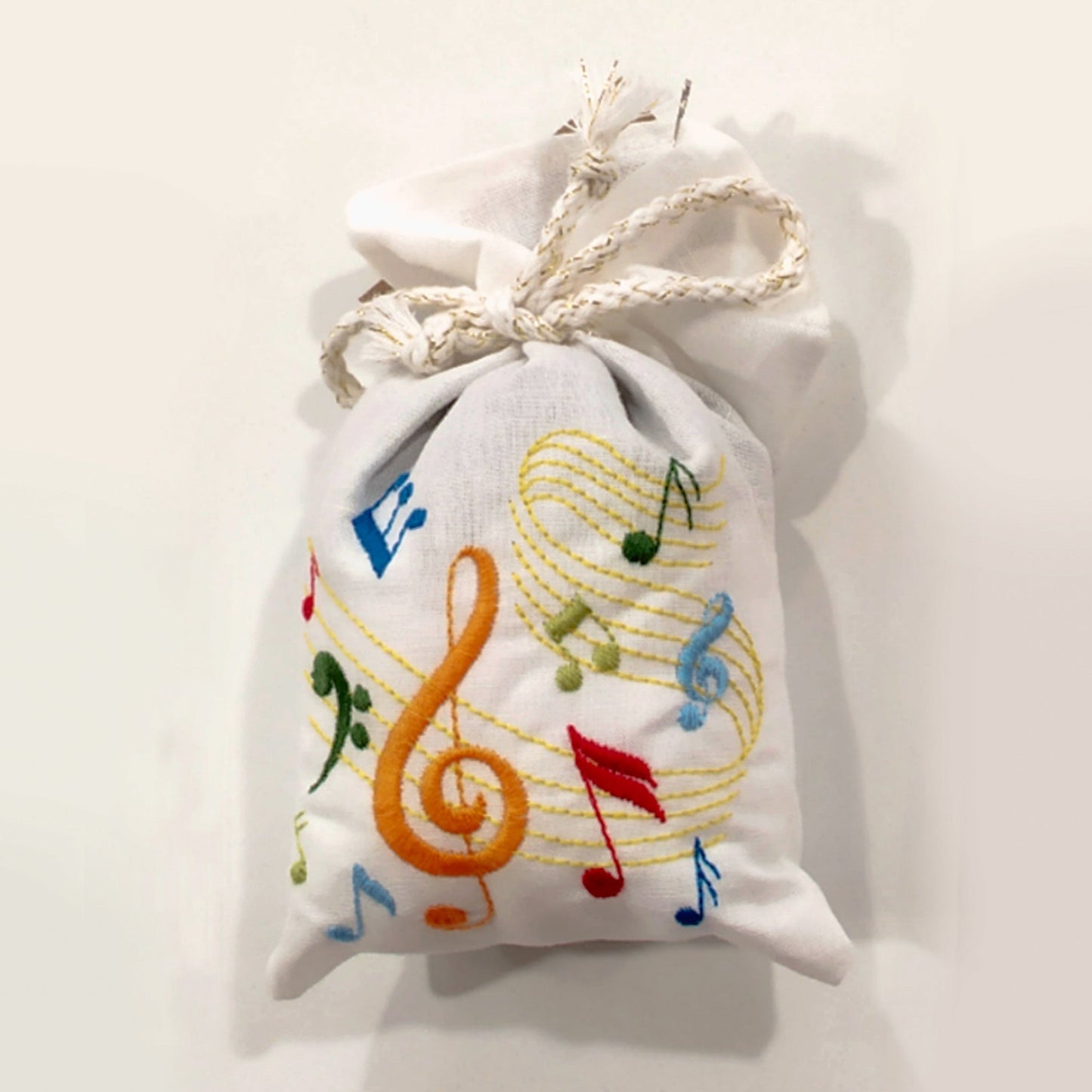 Decorative pouch with musical notes on a white background