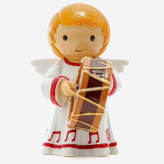 Decorative angel figurine with blonde hair, white robe with red details, and holding a drum on a white background.