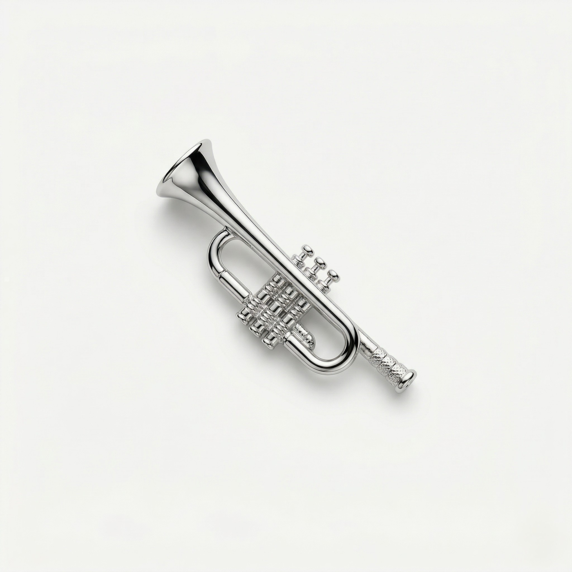 Close-up of trumpet metal lapel pin showing bright finish