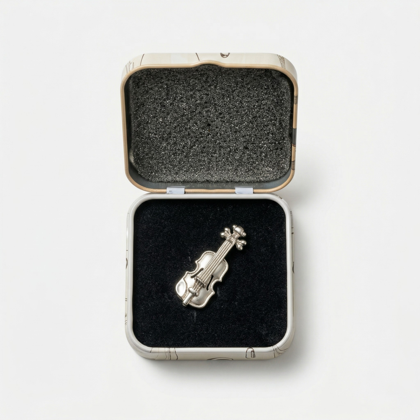 Close-up of violin metal lapel pin showing detail and finish