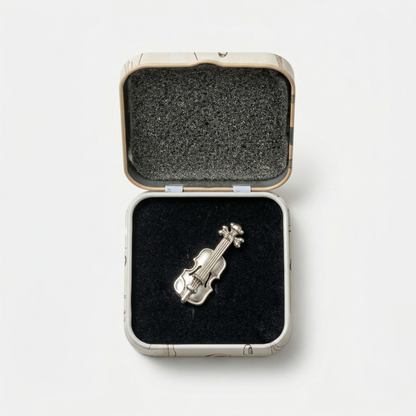 Close-up of violin metal lapel pin showing detail and finish