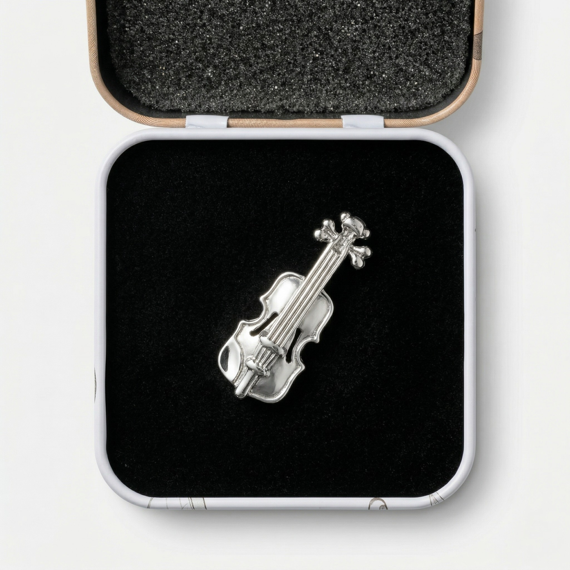 Violin lapel pin with premium black gift box on dark background