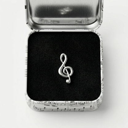 Treble clef lapel pin with premium black gift box on dark background