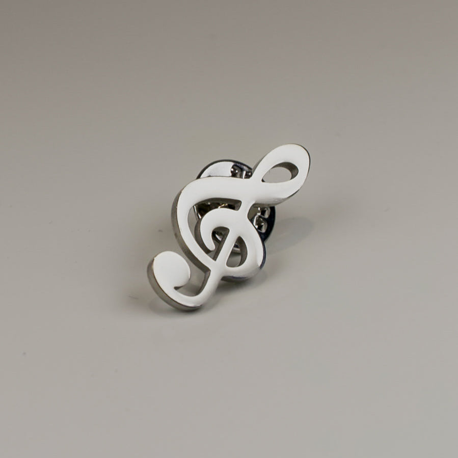 White treble clef-shaped ring on a gray background