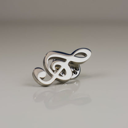 Silver and white decorative item on a reflective surface with a neutral background