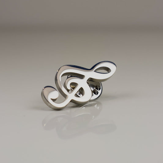 Silver and white decorative item on a reflective surface with a neutral background