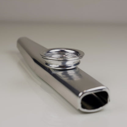 Kazoo instrument on a light gray background