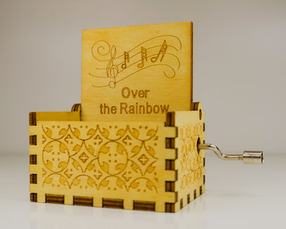 Wooden music box with 'Over the Rainbow' engraving on a light background