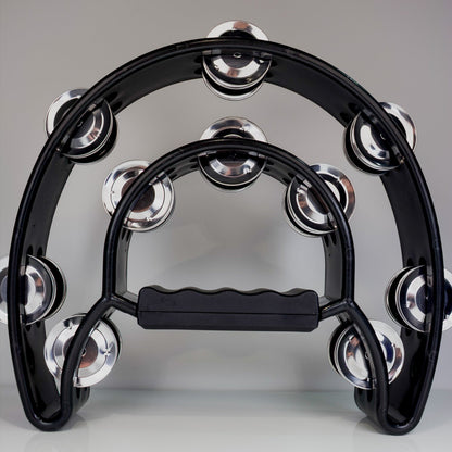 Black tambourine with silver jingles on a gray background