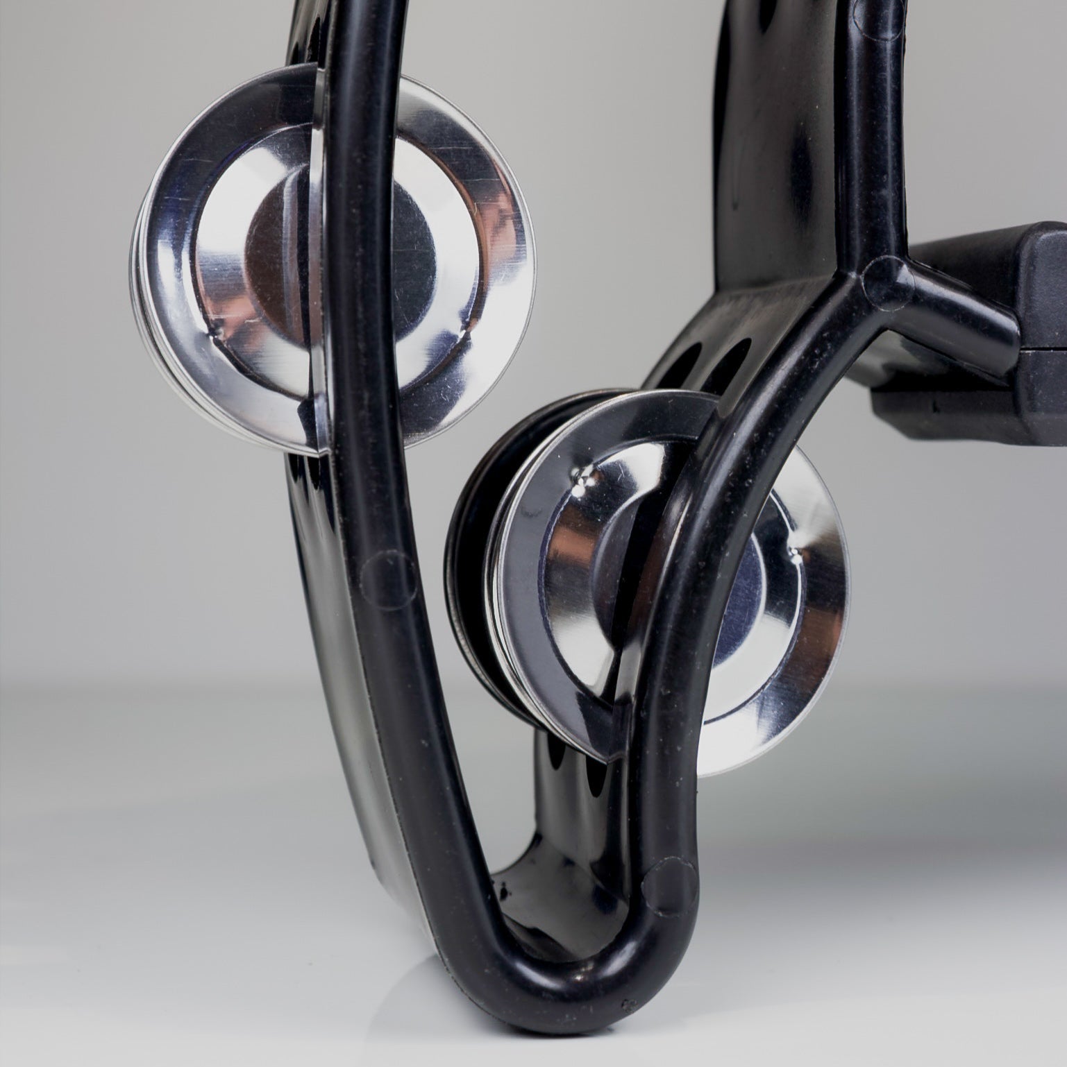 Close-up of a Black tambourine on a gray background