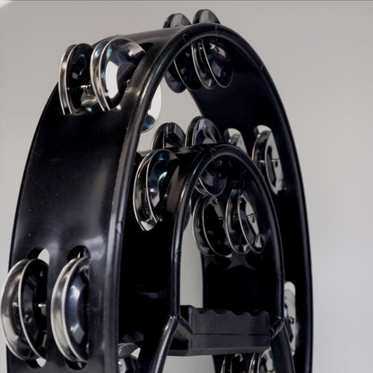 Close-up of a Black tambourine on a gray background