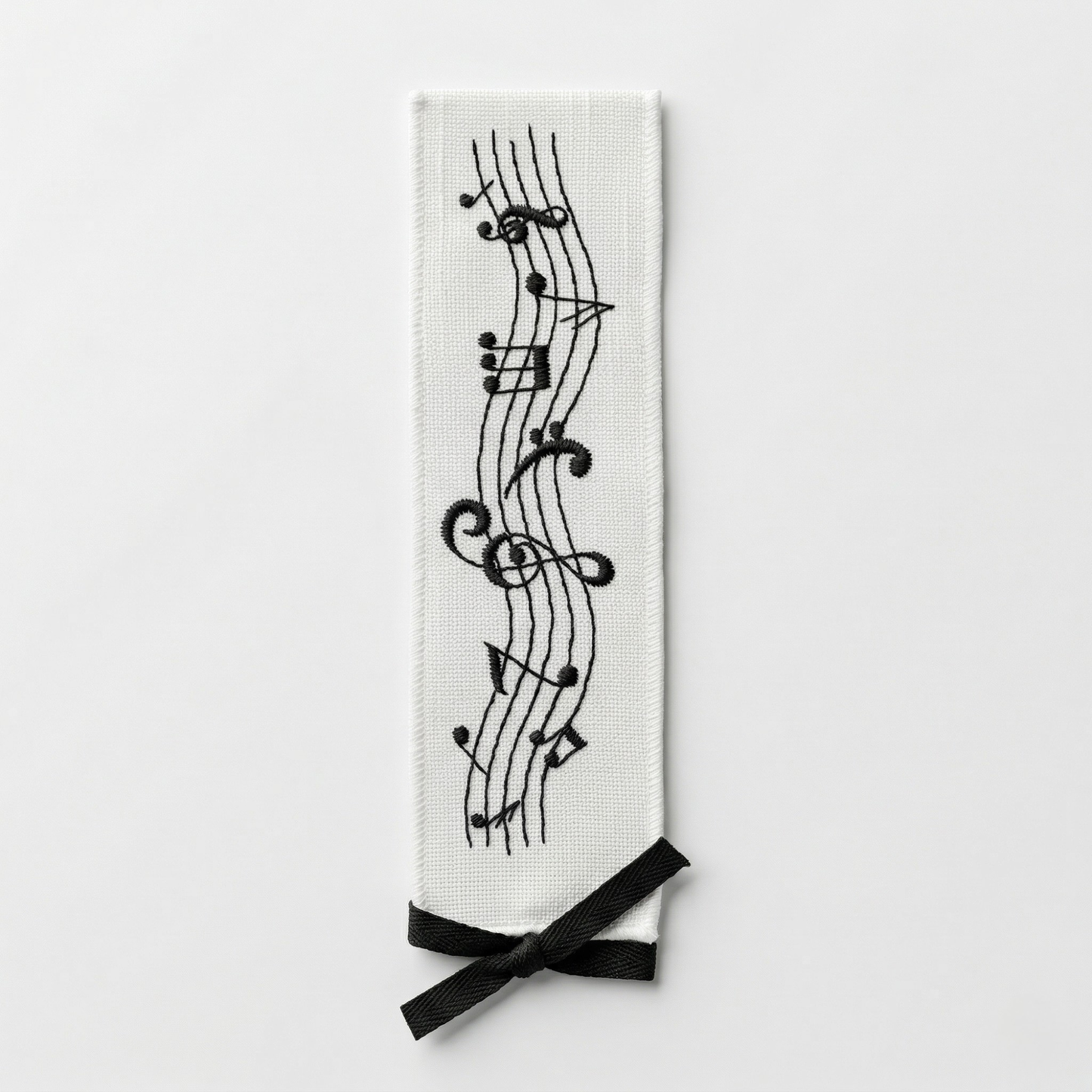 Embroidered fabric bookmark with musical notes design on white background